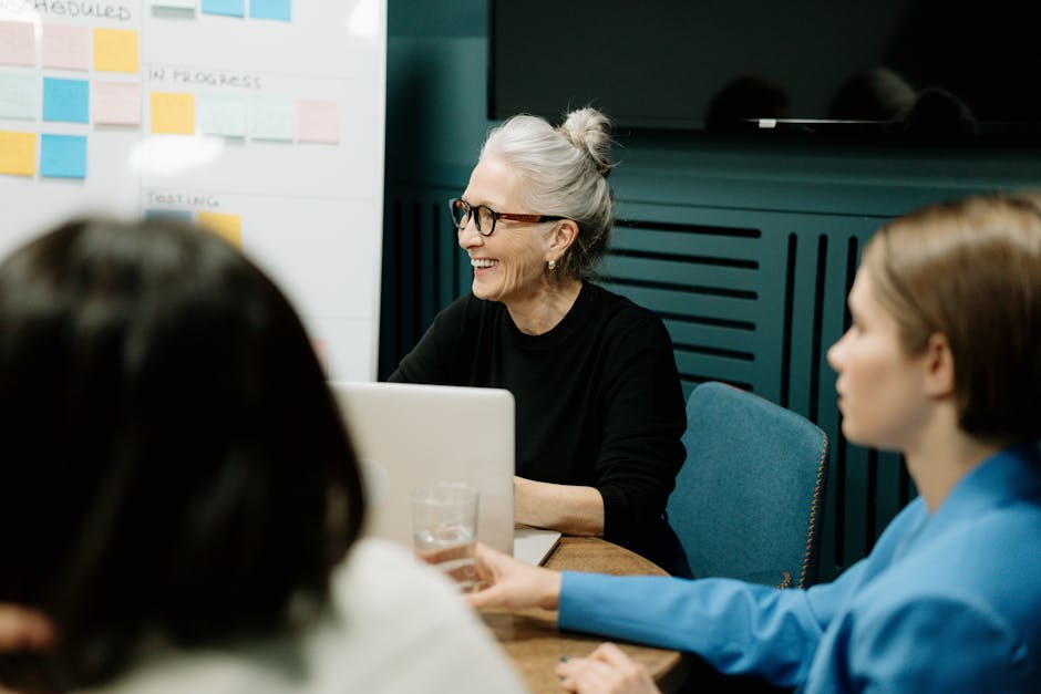 Smiling senior businesswoman leading a diverse team meeting in an office